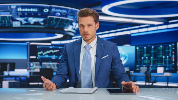 istock Beginning Evening News TV Program: Anchor Presenter Reporting on Business, Economy, Science, Politics. Television Cable Channel Anchorman Talks. Broadcast Network Newsroom Studio Concept. 1407334341