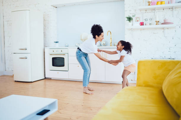istock Smiling black mother playing with daughter 1407340025