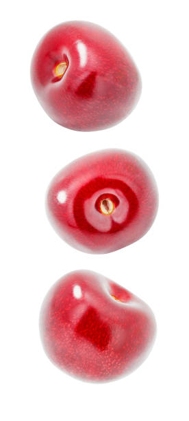istock Cherries, three red cherry berries,  falling, hanging, flying, soaring, isolated on white background with clipping path 1407340465