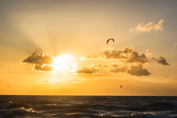 istock kitesurfer doing tricks in sunset at baltic sea 1407340604