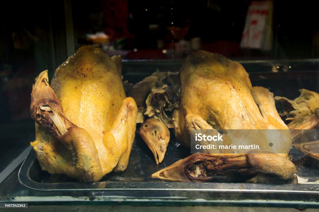 Steamed whole chickens on a glass display Steamed whole chickens on a glass display at a traditional Khmer noodle shop in Mondulkiri, Cambodia Asia Stock Photo