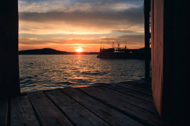 istock Tropical summer sunset at the pier as seen from a bungalow 1407343722