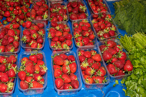 Ripe strawberries sold in clear plastics