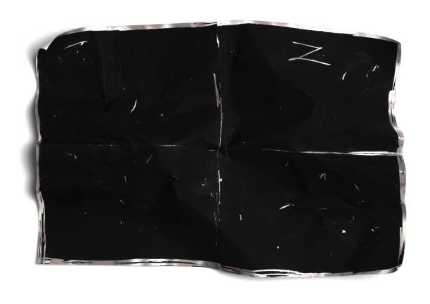 istock Crumpled black paper sheet isolated on white,Old book 1407343876