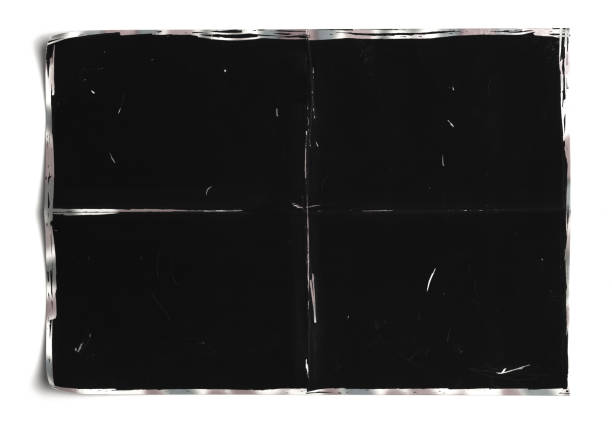 istock Crumpled black paper sheet isolated on white,Old book 1407343877
