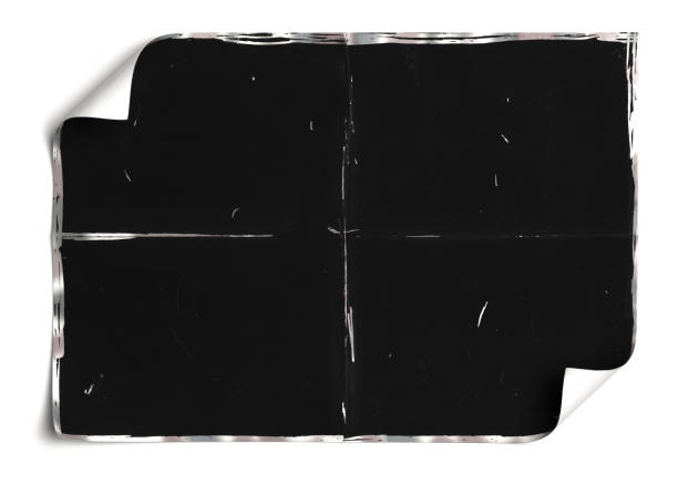 istock Crumpled black paper sheet isolated on white,Old book 1407343878