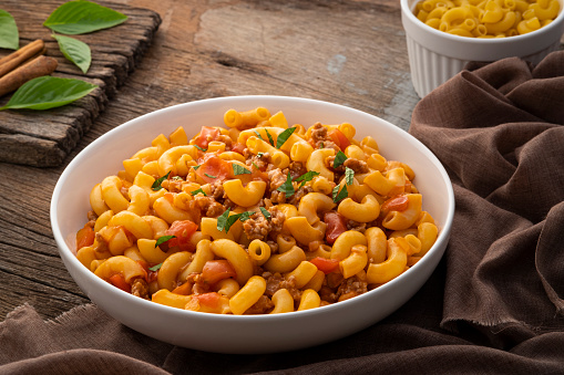 Stir fried macaroni with tomatoes sauce and mince pork on a plate