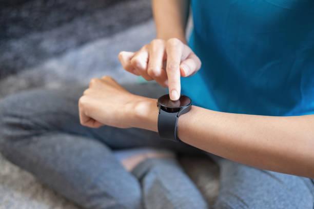 istock Relieve stress, relax muscles, practice breathing, exercise, meditate. Women exercise using smart watch to record exercise data. 1407352647