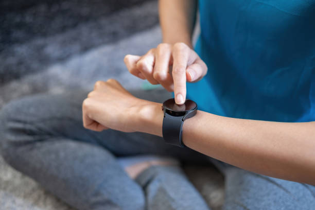 istock Relieve stress, relax muscles, practice breathing, exercise, meditate. Women exercise using smart watch to record exercise data. 1407352655