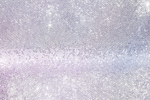 mother-of-pearl background of silver sequins, iridescent silver background for your design