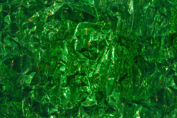 istock Green wrinkled foil with holographic effect. Festive background. 1407352825