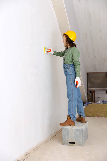 istock Live portrait of young woman, builder wearing helmet using different work tools at a construction site. Gender equality, job, work concept 1407353081