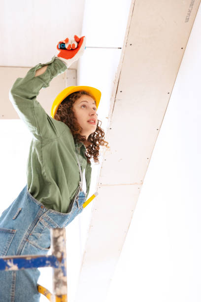 istock Live portrait of young woman, builder wearing helmet using different work tools at a construction site. Gender equality, job, work concept 1407353094