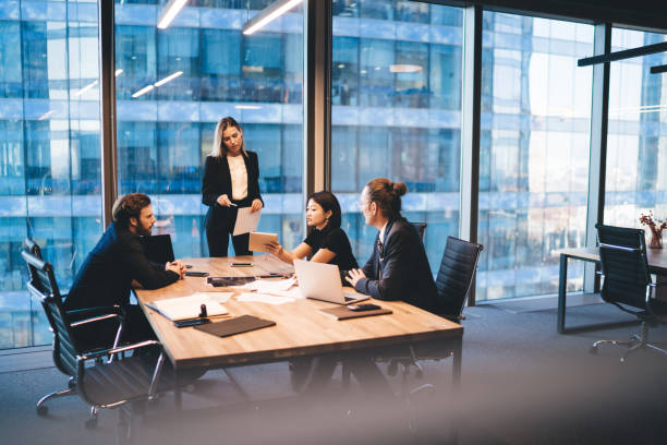 istock Diverse group of colleagues working on project together in boardroom 1407354550