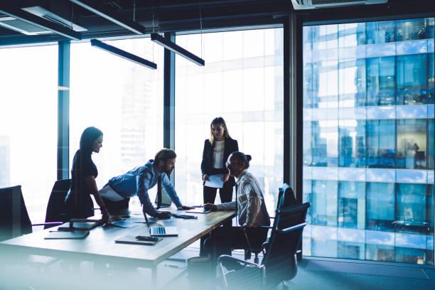 istock Diverse coworkers gathering in office discussing business with excitement 1407354561