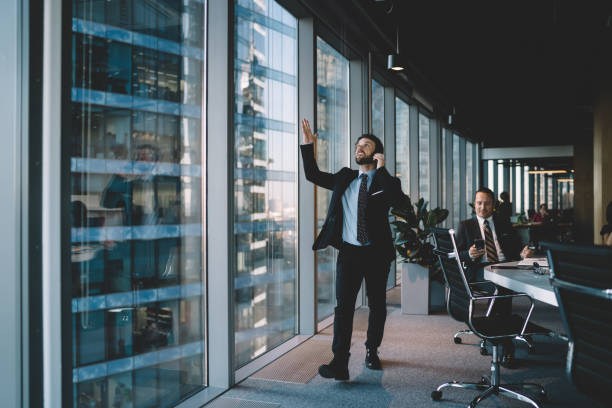 istock Dissatisfied executive manager talking on smartphone in workplace 1407354565