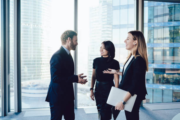istock Young well dressed coworkers in office talking and laughing joyfully 1407354569