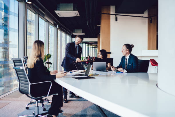 istock Male boss explaining mistakes with report to employees 1407354600
