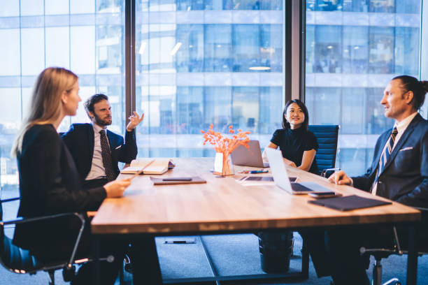 istock Multicultural professional experts in elegant wear discussing productive plan for work of employees during business meeting in conference room, concept of corporate brainstorming and collaboration 1407354629