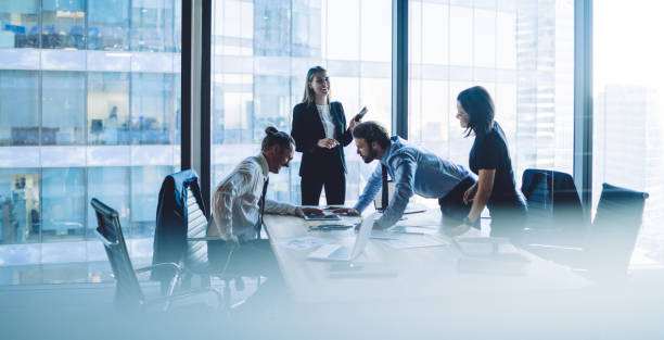 istock Young colleagues working in office discussing business project 1407354642