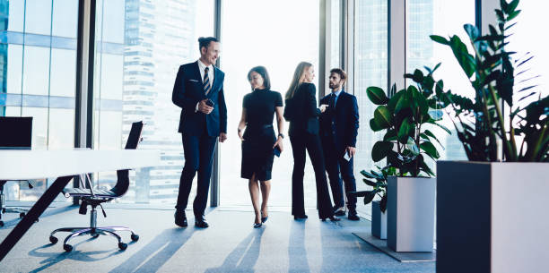 istock Prosperous professional team discussing ideas having business conversation together, diverse confident male managers communicating about cooperation brainstorming in corporate office interior 1407354670