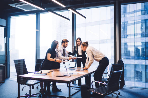 istock Diverse colleagues working in modern office discussing  business 1407355225