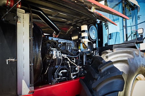 Open engine compartment of a modern tractor, for agricultural or construction work.