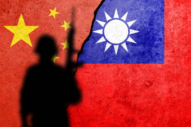 China and Taiwan flags painted on a concrete wall with soldier shadow stock photo
