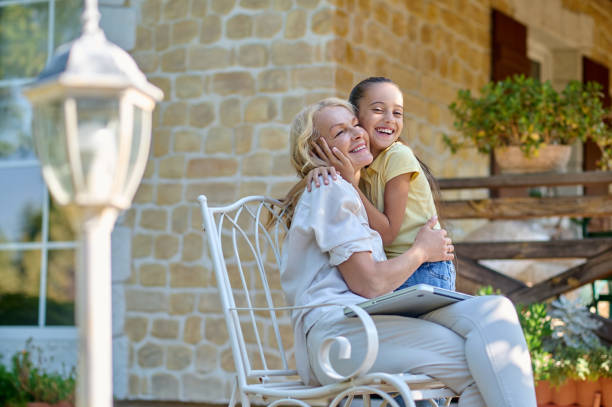istock Mom hugging her daughter and looking happy 1407355798