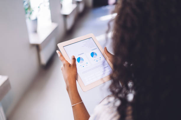 istock Ethnic female employee with tablet searching information 1407355855