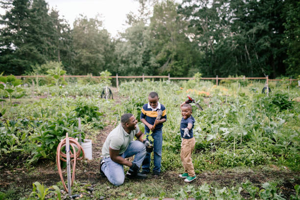 istock Father Gardening With His Sons 1407355894