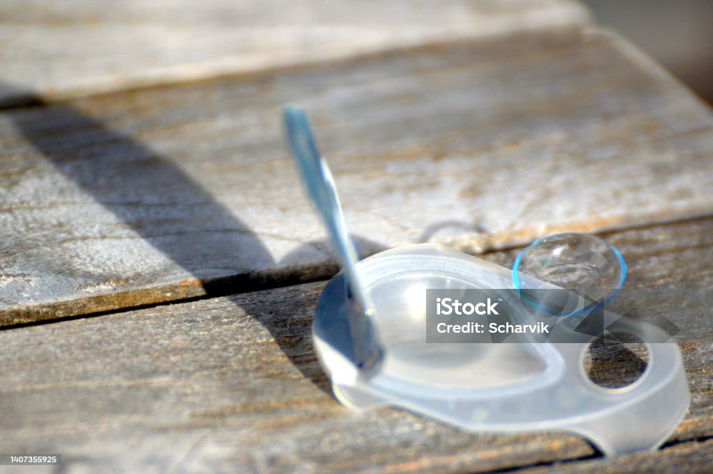 Single Use Contacts Single Use Contact Lens And Container On Wooden Table Stock Photo ...