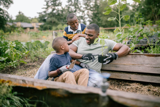 istock Father Gardening With His Sons 1407355937