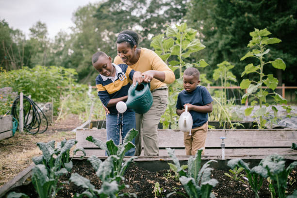 istock Mother Gardening With Her Children 1407355938