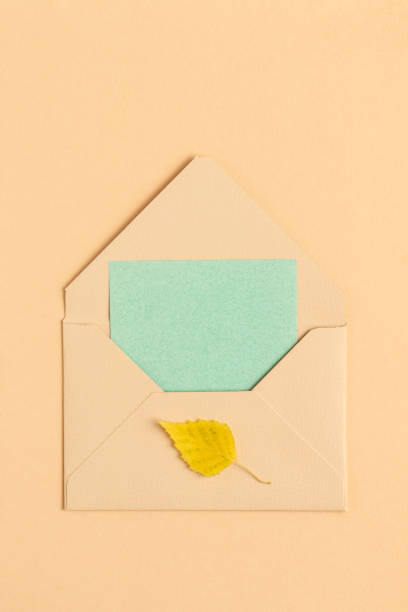 istock Postal envelope with a card and autumn leaf. 1407356562