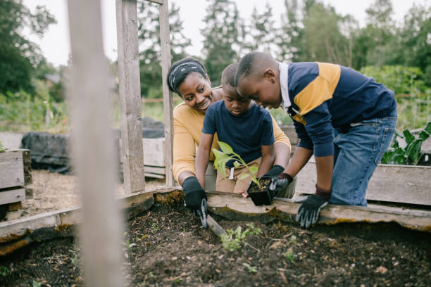 istock Mother Gardening With Her Children 1407356645