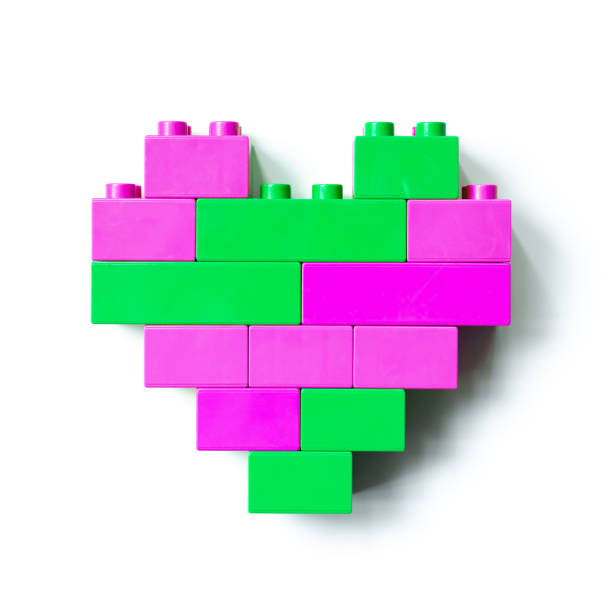 istock Two colors heart from plastic building blocks isolated on white background, top view object, design element, green and raspberry color figure heart from child. Love concept, Valentines card,  games 1407359923