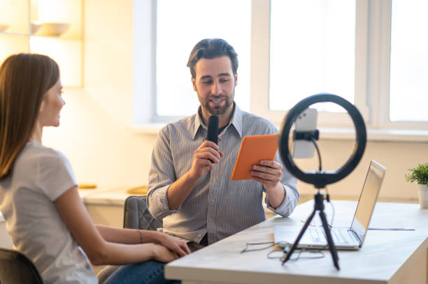 istock Young bearded journalist interviewing a long-haired woman 1407360309