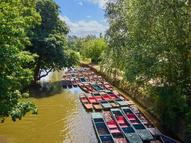 Colorful punting boats in Oxford, UK Colorful punting boats in Cherwell river in Oxford, England, UK, Europe. View from Magdalen bridge punting stock pictures, royalty-free photos & images