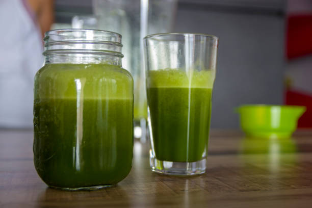 Homemade a green (orange and spinach) smoothie stock photo
