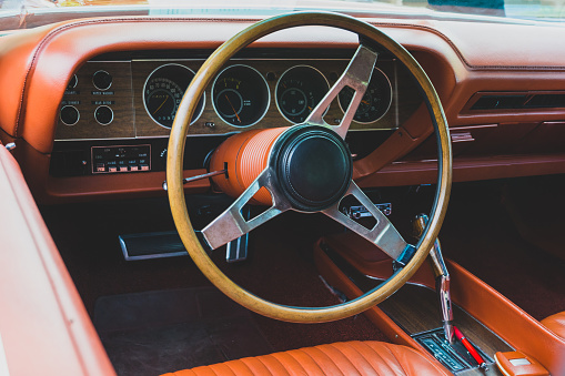 Interior view of old vintage car. View on dashboard of classic car.