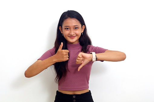 young woman jogging, checking her pulse monitor. 