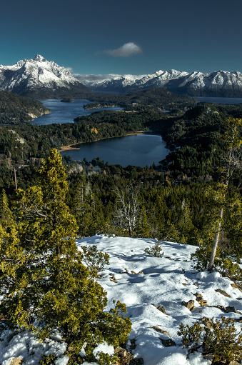 Argentina patagonia landscape with snow capped mountains, lakes, trees and snow
