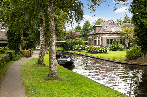 Village of Giethoorn with its picturesque houses on small islands, narrow wooden bridges and beautiful vegetation.