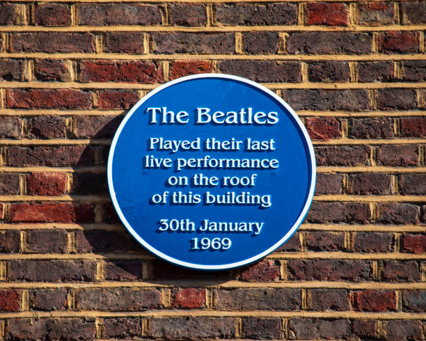A blue plaque on Savile Row in Mayfair, London, marking the location and commemorating the final live performance by The Beatles, which took place on the roof of the building on 30th January 1969.