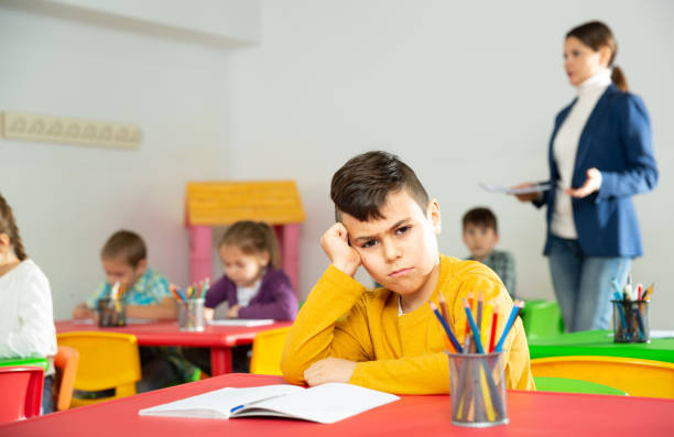 istock Upset boy in schoolroom 1407372869