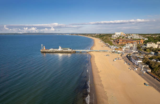 the drone aerial view of the bournemouth beach, observation wheel and pier. - bournemouth imagens e fotografias de stock