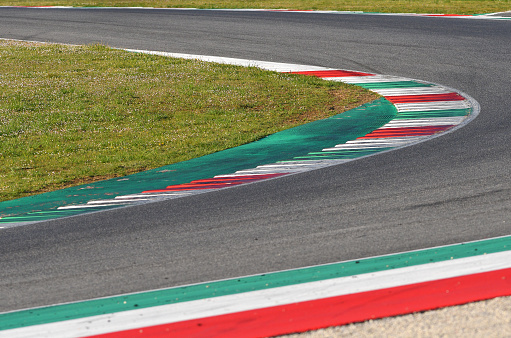 Close front view of a red race car on a track. High resolution 3D render.