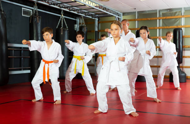 istock Karate kids in kimono performing kata moves 1407373248