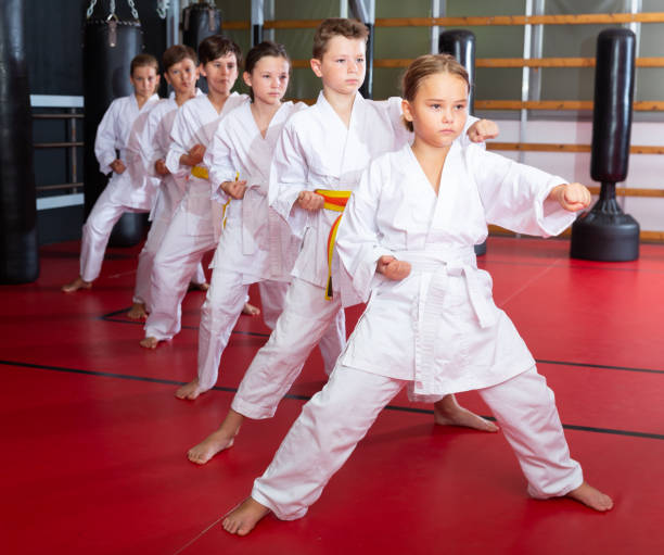 istock Karate kids in kimono performing kata moves 1407373250